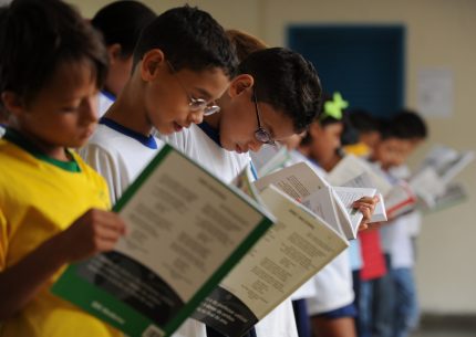 Crianças fazem leitura coletiva em escola. Crédito: EBC