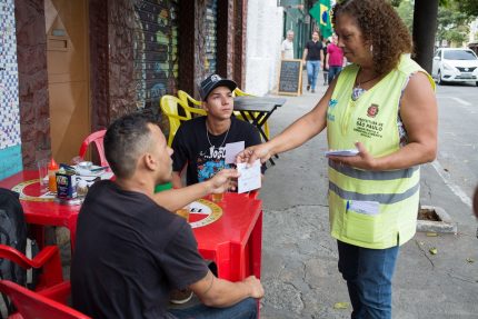 Orientadora social abordagem clientes de bar em mesa na Vila Madalena